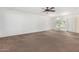Spacious living room with ceiling fan and view to backyard at 18202 N 99Th Dr, Sun City, AZ 85373