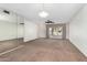 Bright living room with mirrored wall and view to the patio at 18202 N 99Th Dr, Sun City, AZ 85373