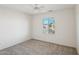 Well-lit bedroom with ceiling fan and window coverings at 19241 N Emerald Cove Way, Surprise, AZ 85387