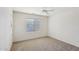 Bright bedroom with ceiling fan and neutral carpeting at 19241 N Emerald Cove Way, Surprise, AZ 85387