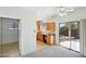 Kitchen with wood cabinets, a sliding door to patio, and access to laundry room at 19241 N Emerald Cove Way, Surprise, AZ 85387