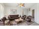 Spacious living room with leather seating, a coffee table, and decorative artwork at 19241 N Emerald Cove Way, Surprise, AZ 85387