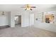 Bright living room with neutral carpeting and built-in shelving at 19241 N Emerald Cove Way, Surprise, AZ 85387