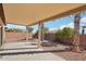 Covered patio with flagstone flooring and landscaping at 19241 N Emerald Cove Way, Surprise, AZ 85387