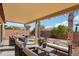 Covered patio with seating area, providing an outdoor space for relaxation and entertaining at 19241 N Emerald Cove Way, Surprise, AZ 85387