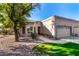 House exterior with a two-car garage, landscaping, and walkway at 19516 N 88 Th Dr, Peoria, AZ 85382