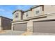 Stylish two-story townhome with stone veneer accents, neutral stucco, and a spacious two-car garage at 21028 N 58Th Way, Phoenix, AZ 85054