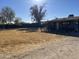 Front view of a ranch style home with a large lot at 218 N Apache Rd, Buckeye, AZ 85326