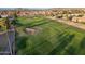 Aerial view of a green golf course and residential area at 2213 N Recker Rd, Mesa, AZ 85215