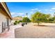 Landscaped backyard with gravel, fruit trees, and tile patio at 25801 N Abajo Dr, Rio Verde, AZ 85263