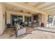 Relaxing covered patio with fireplace and ceiling fans at 25971 W Taro Dr, Buckeye, AZ 85396