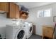 Convenient laundry room with washer, dryer, and extra cabinets at 261 W 21St Ave, Apache Junction, AZ 85120