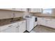 Laundry room with white cabinets, granite countertops, and a utility sink at 33504 N 87Th St, Scottsdale, AZ 85266