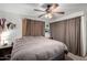 Spacious bedroom with ceiling fan, large bed, and neutral color palette at 3428 W Vogel Ave, Phoenix, AZ 85051