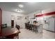 Kitchen with white cabinets, breakfast bar, and dining area at 3428 W Vogel Ave, Phoenix, AZ 85051