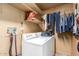 A laundry room with washer, dryer, and shelving at 3428 W Vogel Ave, Phoenix, AZ 85051