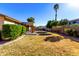 Landscaped backyard with grassy area and covered patio at 3479 E Esplanade Ct, Gilbert, AZ 85297
