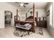 Spacious main bedroom with a large four-poster bed and ensuite bathroom at 3479 E Esplanade Ct, Gilbert, AZ 85297