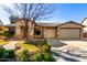 Single-story home with a landscaped front yard, two-car garage, and stone pathway at 3479 E Esplanade Ct, Gilbert, AZ 85297