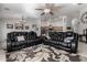 Relaxing living room with two black leather sofas and a large area rug at 3479 E Esplanade Ct, Gilbert, AZ 85297