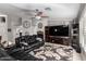 Spacious living room with leather furniture, a large TV, and a fireplace at 3479 E Esplanade Ct, Gilbert, AZ 85297