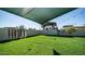 Spacious grassy backyard with shade structure and gate at 3737 W Morrow Dr, Glendale, AZ 85308