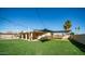 Large backyard with a grassy area, patio, and pool at 3737 W Morrow Dr, Glendale, AZ 85308