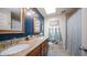 Bathroom with dual sinks, granite countertops, and a shower/tub combo at 3737 W Morrow Dr, Glendale, AZ 85308