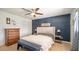 Main bedroom with a king-size bed and an accent wall at 3737 W Morrow Dr, Glendale, AZ 85308