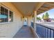 Covered front porch with entry door and windows at 3737 W Morrow Dr, Glendale, AZ 85308