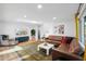 Bright living room with comfy leather sectional and stylish rug at 3802 E Piccadilly Rd, Phoenix, AZ 85018