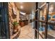 Elegant entryway with stone floors, a fireplace, and metal-framed doors at 38643 N 58Th Pl, Cave Creek, AZ 85331