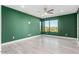 Bedroom with green walls, wood-look floors, and a large window at 3918 W Bowen Ave, Glendale, AZ 85308