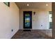 Modern glass and metal front door with a small brick patio at 3918 W Bowen Ave, Glendale, AZ 85308