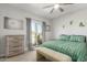 Bright bedroom featuring slider to balcony, neutral palette, and lovely cactus wall art at 4263 W Jasper Dr, Chandler, AZ 85226