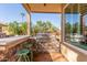 Outdoor kitchen with built in BBQ, counter seating and natural stone finish at 4263 W Jasper Dr, Chandler, AZ 85226