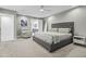 Spacious bedroom with gray upholstered bed and light gray carpet at 4712 E Palo Verde Dr, Phoenix, AZ 85018
