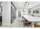 Modern kitchen with white and gray cabinets, large island and stainless steel appliances at 4712 E Palo Verde Dr, Phoenix, AZ 85018