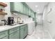 Bright laundry room with green cabinets and modern appliances at 4712 E Palo Verde Dr, Phoenix, AZ 85018