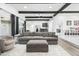 Open living room with gray sectional and ottoman, hardwood floors at 4712 E Palo Verde Dr, Phoenix, AZ 85018