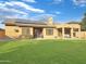 Landscaped backyard with patio, solar panels and grassy area at 6623 W Robin Ln, Glendale, AZ 85310