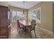 Formal dining room with wood table and chairs, and large windows at 6623 W Robin Ln, Glendale, AZ 85310