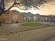 Single-story home with landscaped yard, two-car garage, and attractive curb appeal at 6623 W Robin Ln, Glendale, AZ 85310