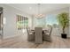 Bright dining room with chandelier and seating for six at 7805 W Noble Prairie Way, Florence, AZ 85132