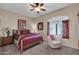 Bedroom with wooden bed frame and window with plantation shutters at 815 E Silverwood Dr, Phoenix, AZ 85048