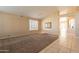 Bright living room with tile and carpet flooring, and view of kitchen at 9071 E Rockwood Dr, Scottsdale, AZ 85255