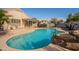 Inviting kidney-shaped pool with patio and rock features at 9071 E Rockwood Dr, Scottsdale, AZ 85255