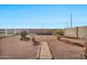 Landscaped backyard with brick pathway at 9109 S 220Th Dr, Buckeye, AZ 85326