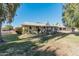 Large backyard with grassy area and home view at 10407 W Desert Forest Cir, Sun City, AZ 85351