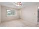 Bright bedroom with ceiling fan, carpet flooring, and window coverings at 10407 W Desert Forest Cir, Sun City, AZ 85351